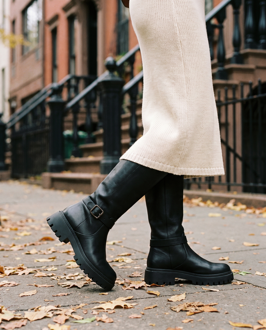 Knee-High Boots with Buckle Strap and Lug Sole — walking on a New York street in autumn