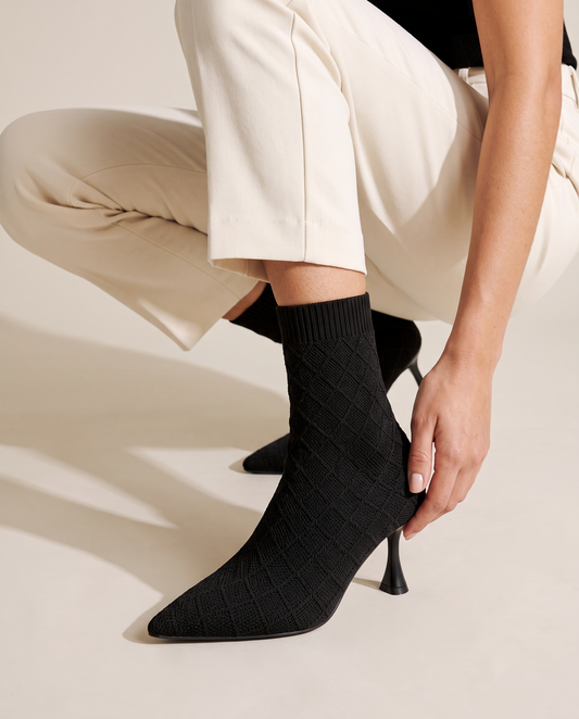 Pointed Toe Sock Boots in Stretch Knit — worn, crouching