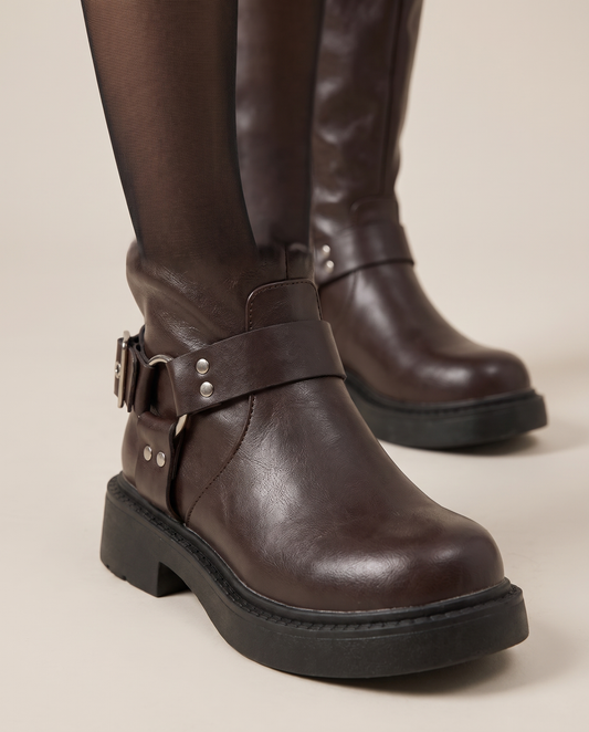 Biker boot harness O-ring, buckle and lug sole close-up
