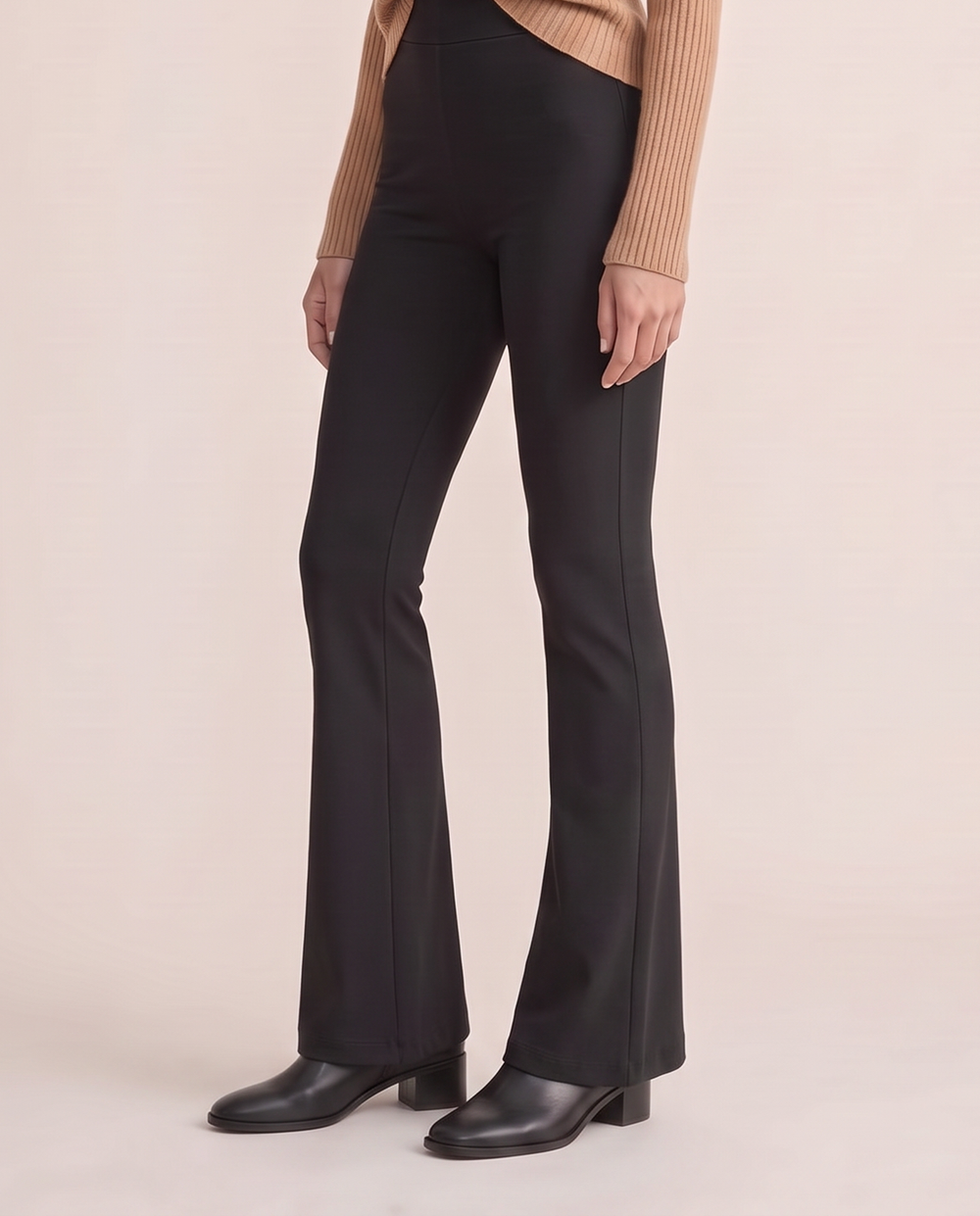 Black stretch flare pants, waist-down view