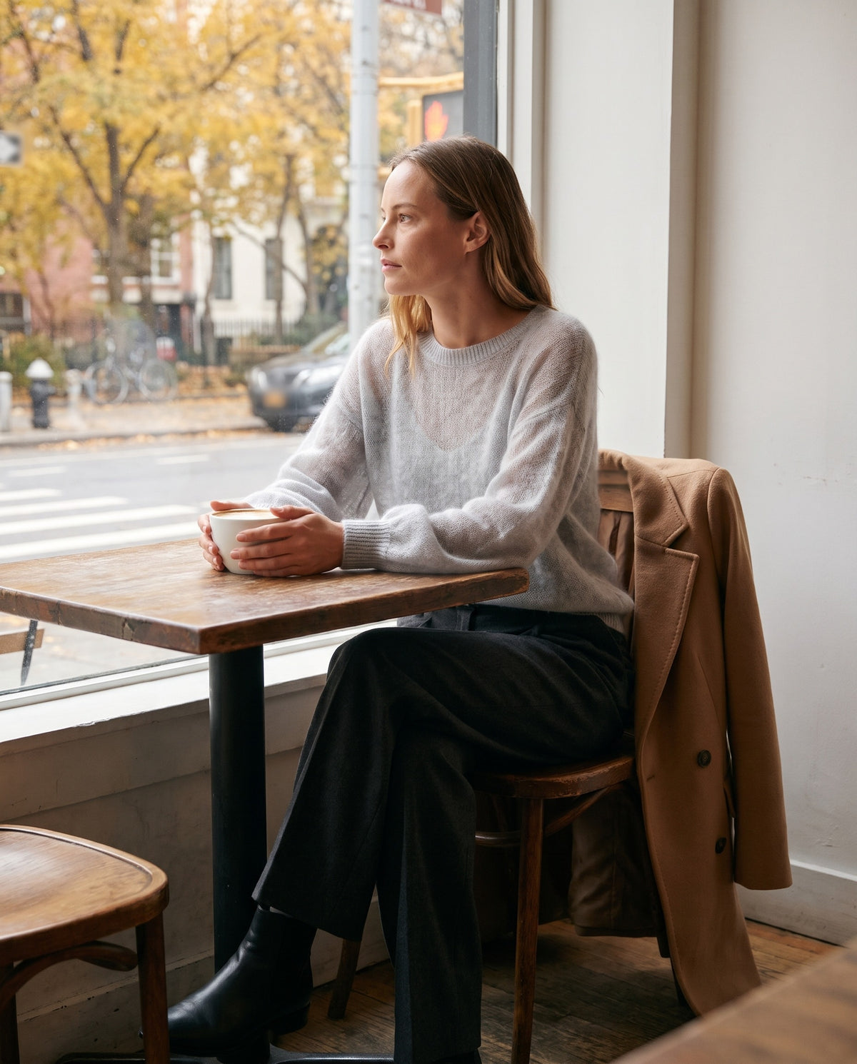 Women's Cashmere Silk Sweater — light gray, worn at a New York cafe window in fall