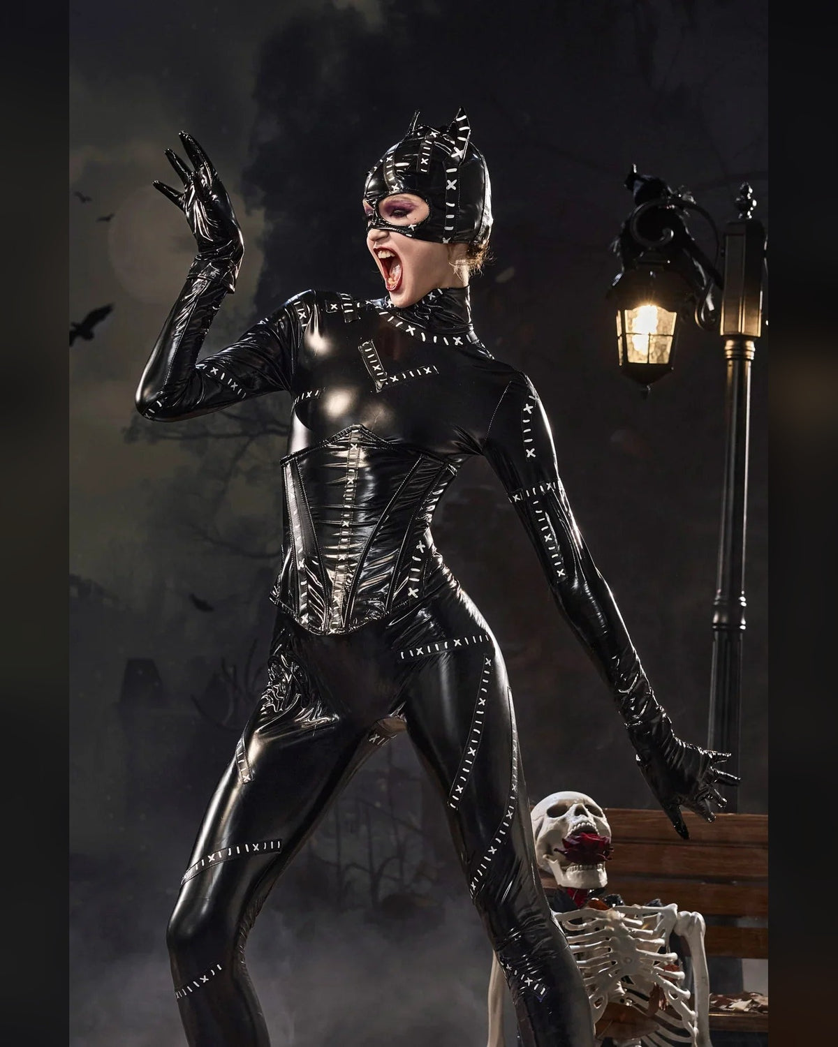 Women's glossy black cat catsuit costume set – styled pose with mask