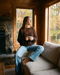 Women's Cashmere Silk Sweater — cocoa brown, worn with jeans in a cozy cabin