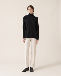 Erice Relaxed Loose-Fit Fine Knit Turtleneck Sweater — black, studio front