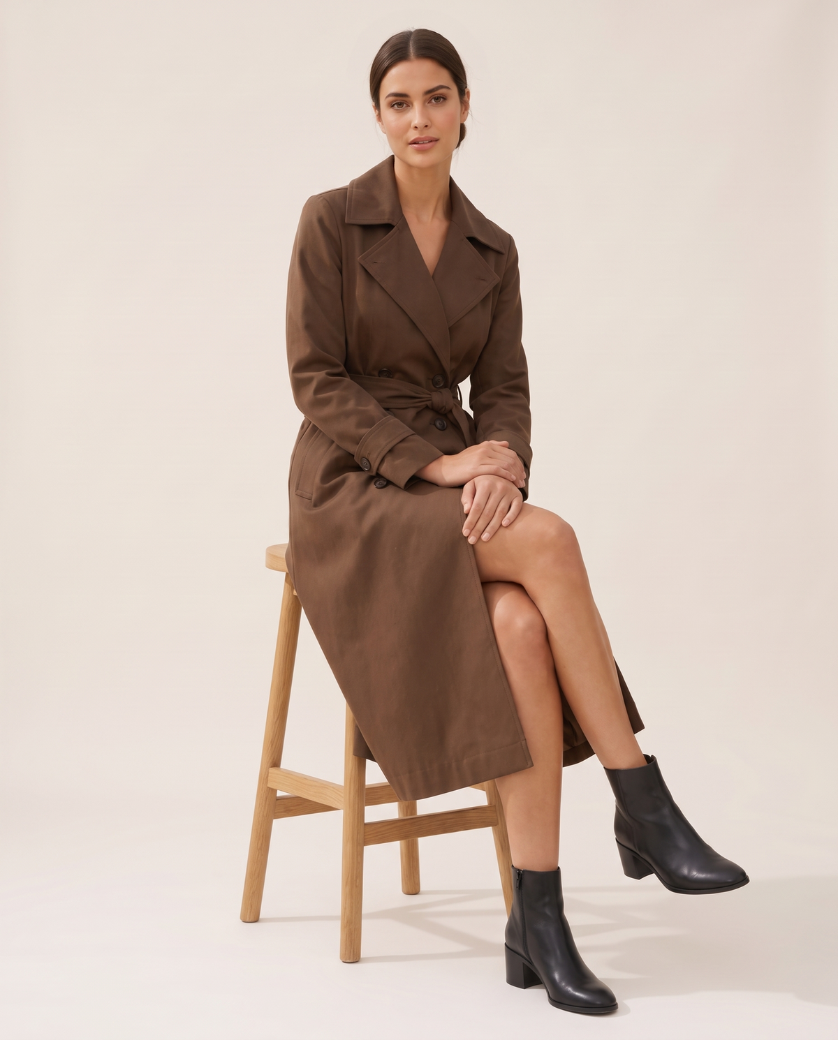 Brown Double-Breasted Belted Trench Coat — worn seated