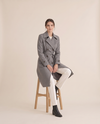 Women's Double-Breasted Trench Coat — worn seated
