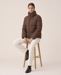 Classic Padded Puffer Jacket with Zip Front — worn seated