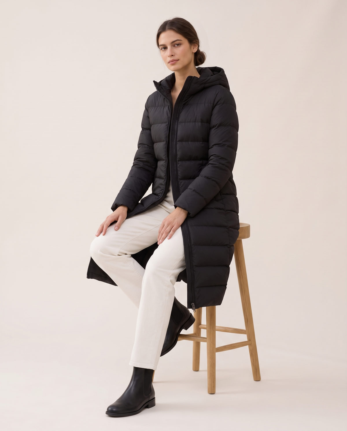 Longline Hooded Puffer Coat with Welt Pockets — worn seated
