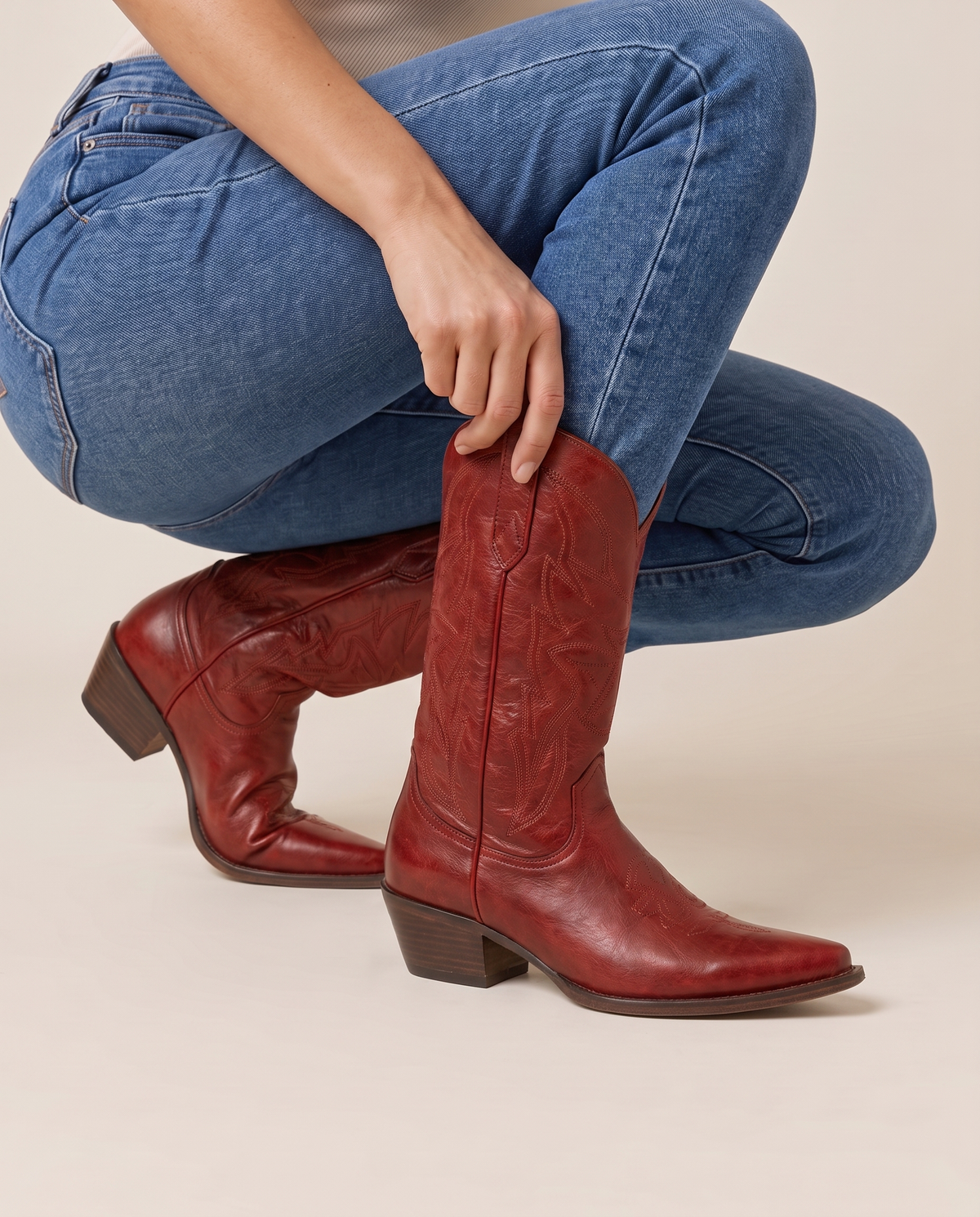 Red Cowboy Boots for Women, Mid-Calf Western Style — pulling on the boot with jeans