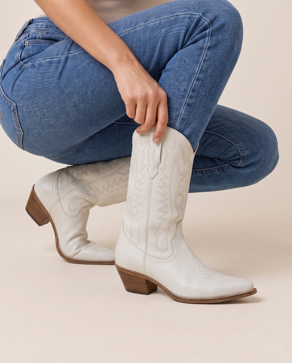 White Cowboy Boots for Women, Mid-Calf Western Style — pulling on the boot with jeans