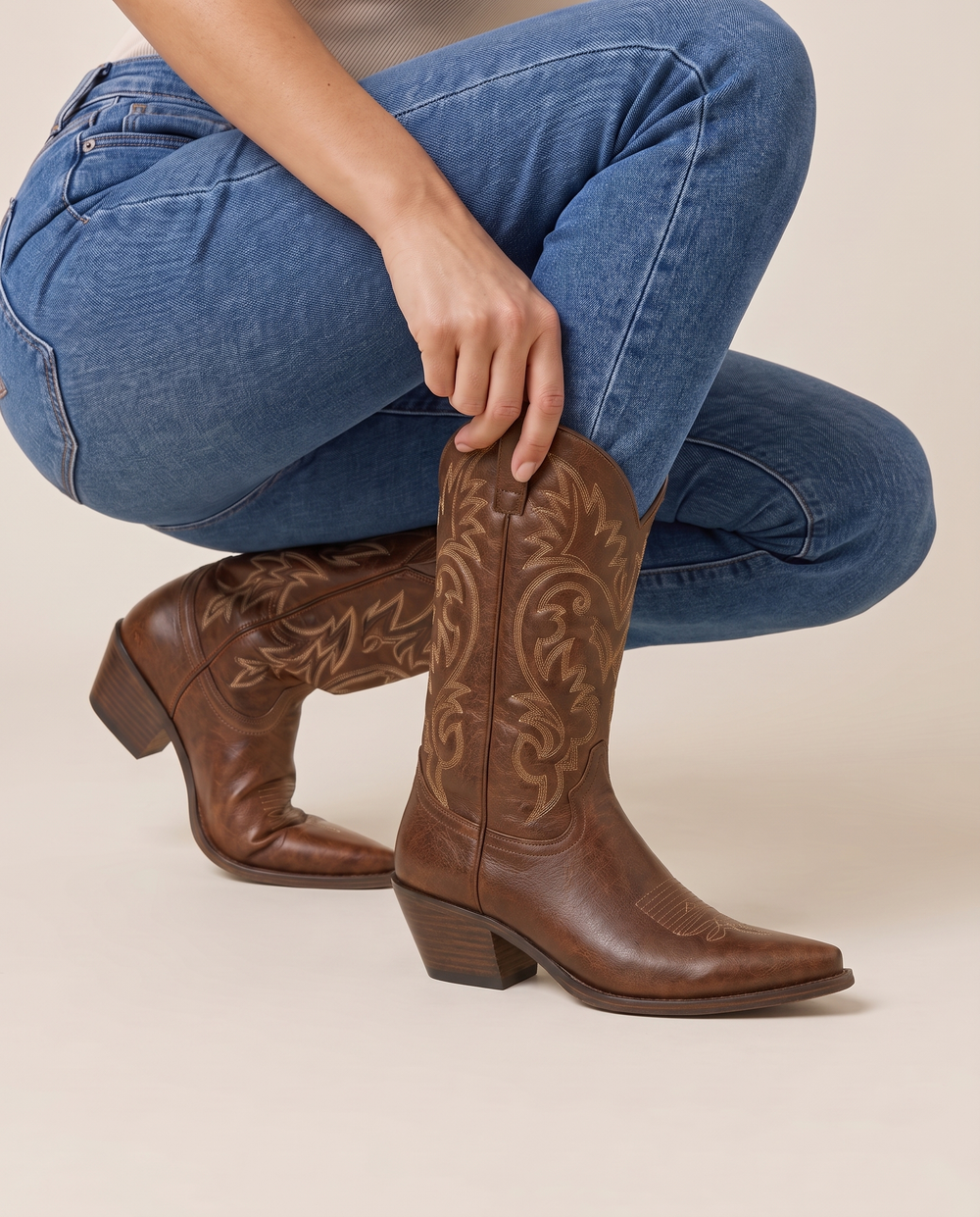 Genuine Leather Cowboy Boots with Embroidery — pulling on the boot with jeans