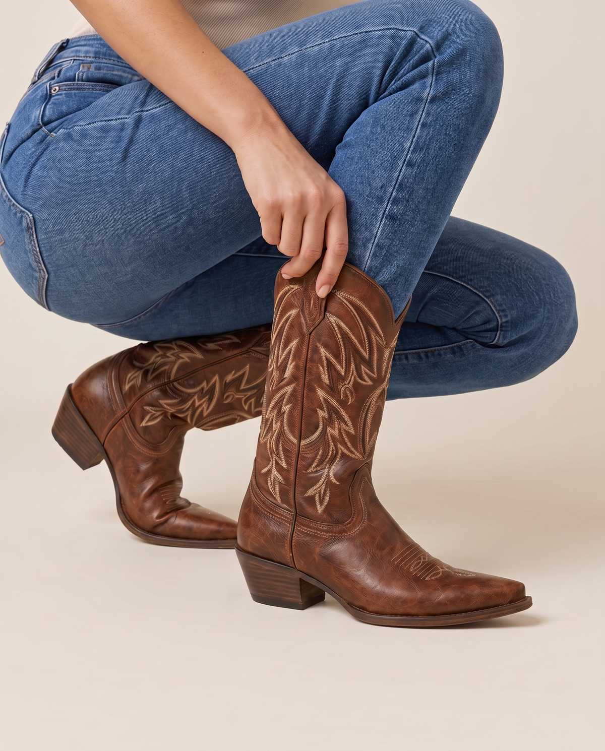 Brown Cowboy Boots for Women, Mid-Calf Western Style — pulling on the boot with jeans