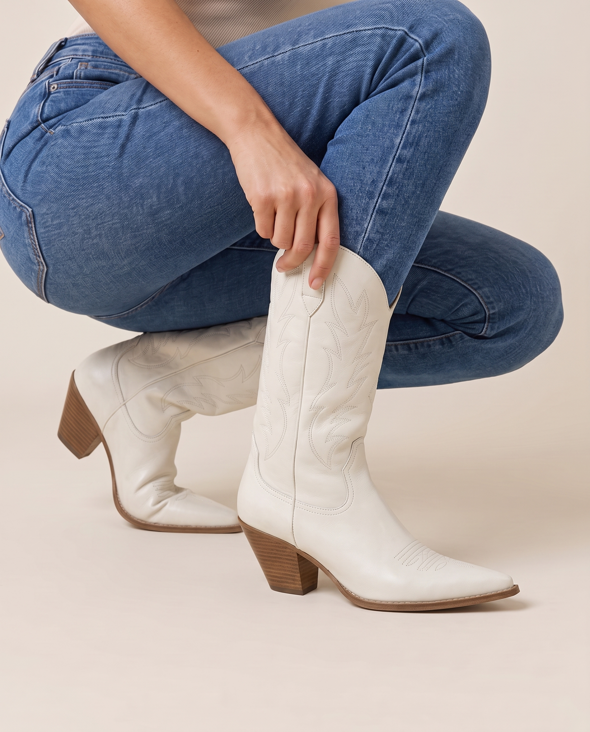 Western Boots with Cushioned Footbed and Breathable Lining — pulling on the boot with jeans