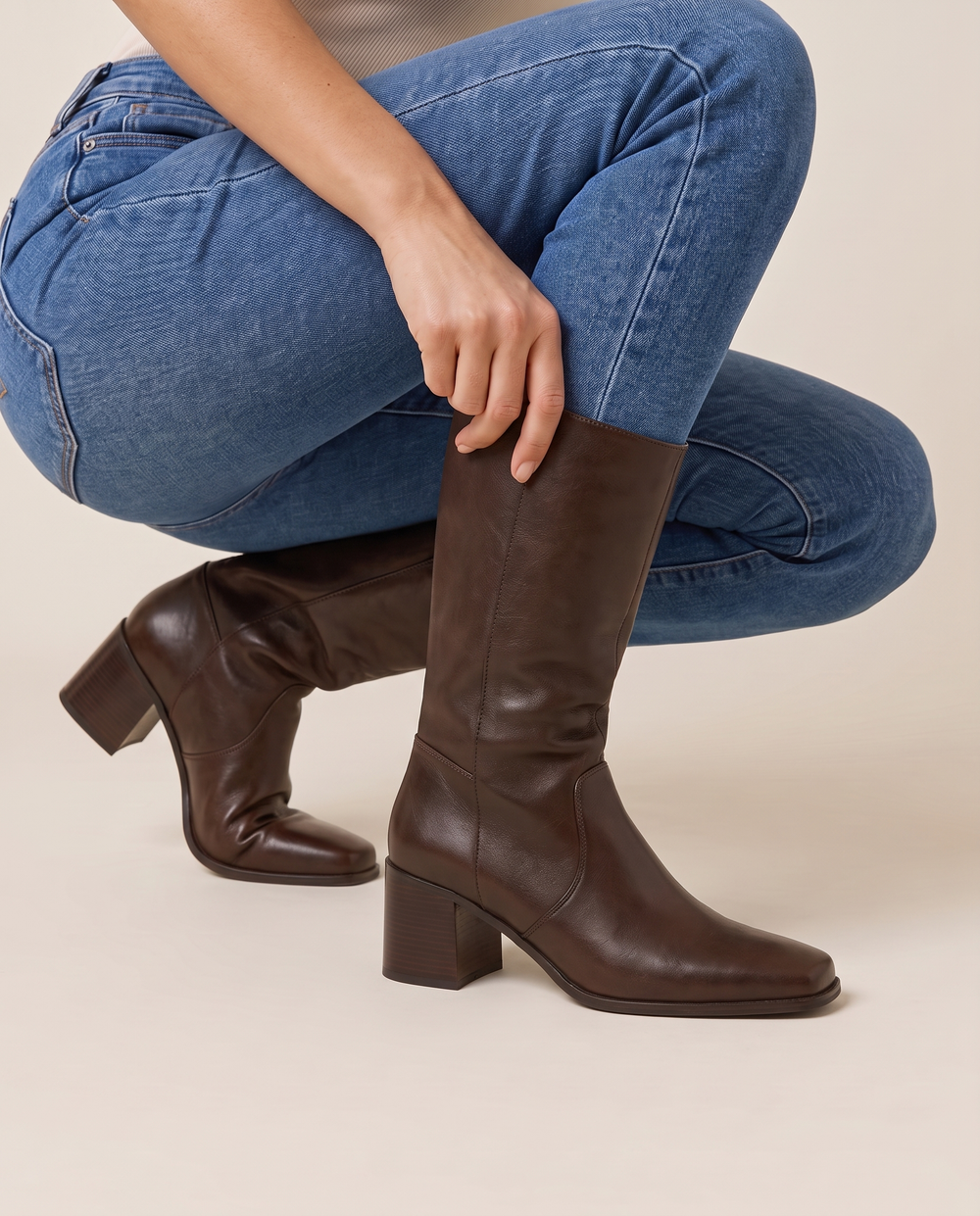 Women's Mid-Calf Boots with Square Toe and Block Heel — pulling on the boot with jeans