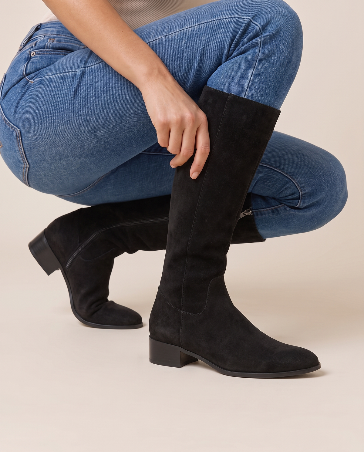 Knee-High Boots with Cushioned Footbed and Side Zipper — pulling on the boot with jeans