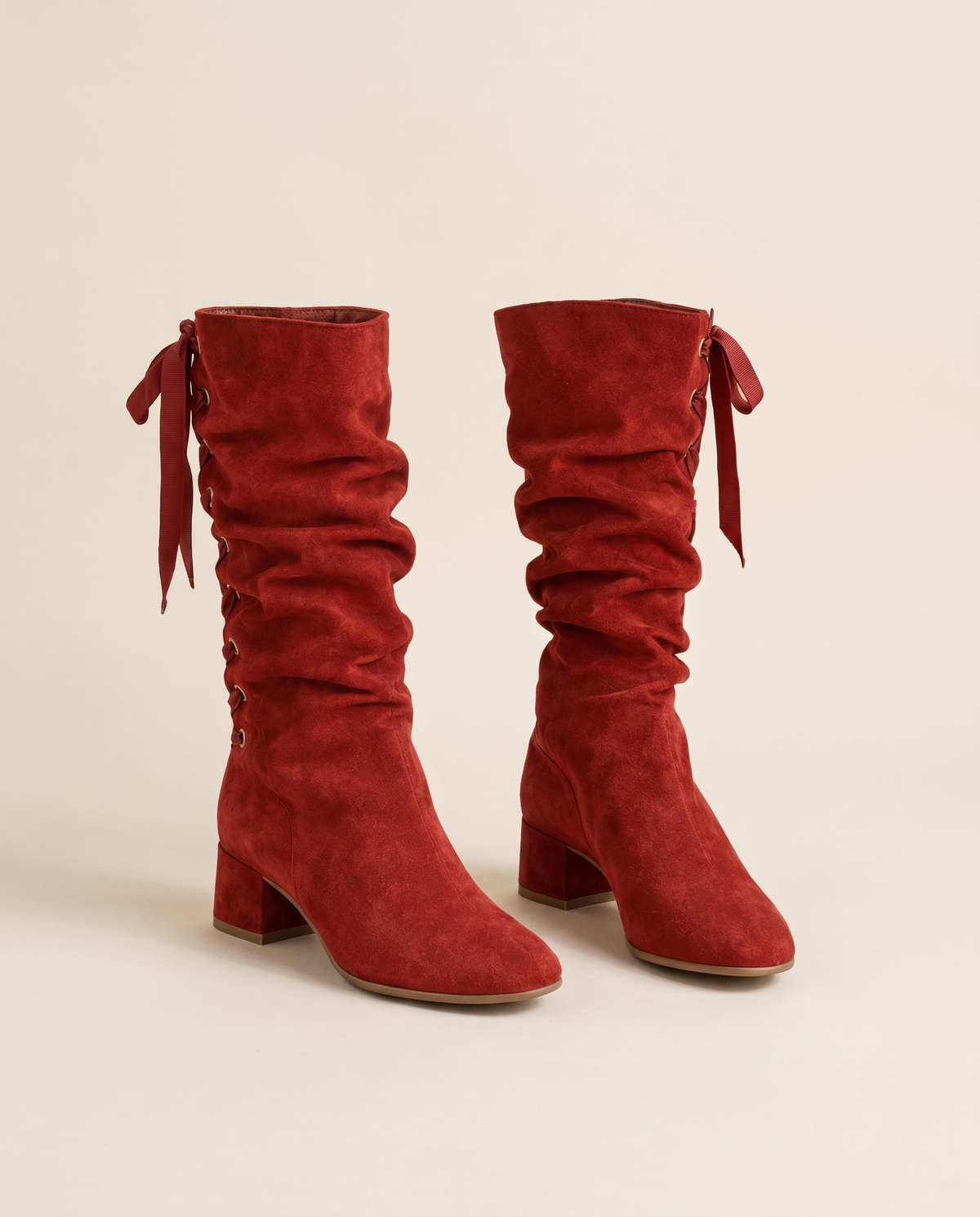 Slouchy Mid-Calf Boots with Ribbon Lace-Up Back — red suede, pair, studio