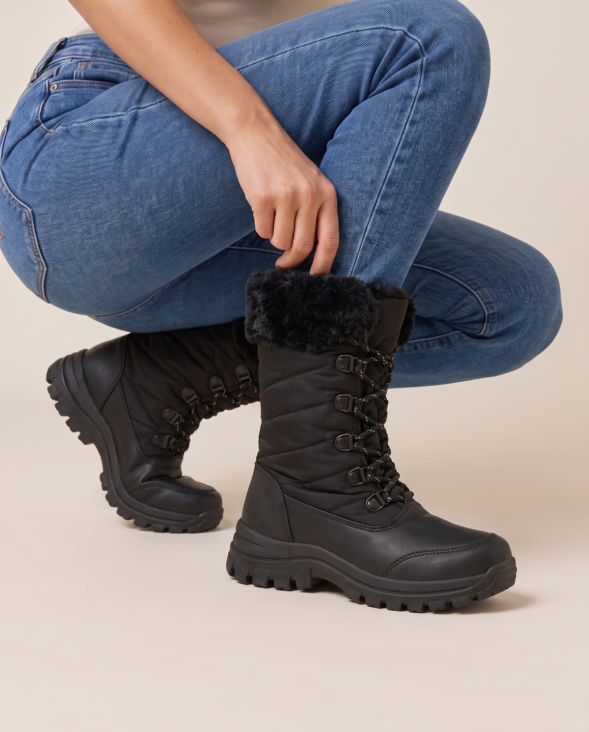 Women's Snow Boots with Plush Lining and Non-Slip Sole — pulling on the boot with jeans