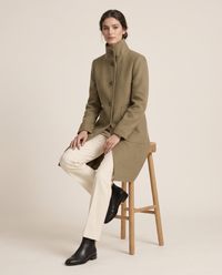 Women's Stand-Collar Coat with Deep Pockets — worn seated