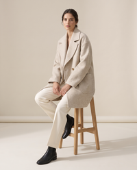 Oversized Double-Breasted Wool-Blend Coat — worn seated