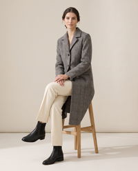 Long Checked Wool-Blend Coat — worn seated