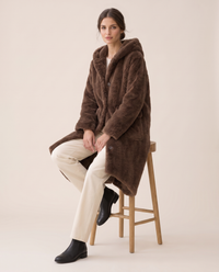 Hooded Faux Fur Longline Coat — worn seated