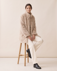 Faux Fur Coat with Quilted Lining — worn seated