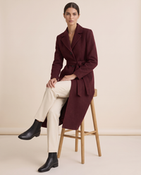 Burgundy Belted Long Coat for Women — worn seated