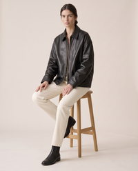 Oversized Soft Leather Jacket with Fluid Drape — worn seated