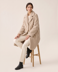 Plush Fleece Coat with Wide Lapels — worn seated