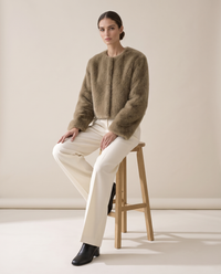 Cropped Faux Fur Jacket with Hidden Closure — worn seated