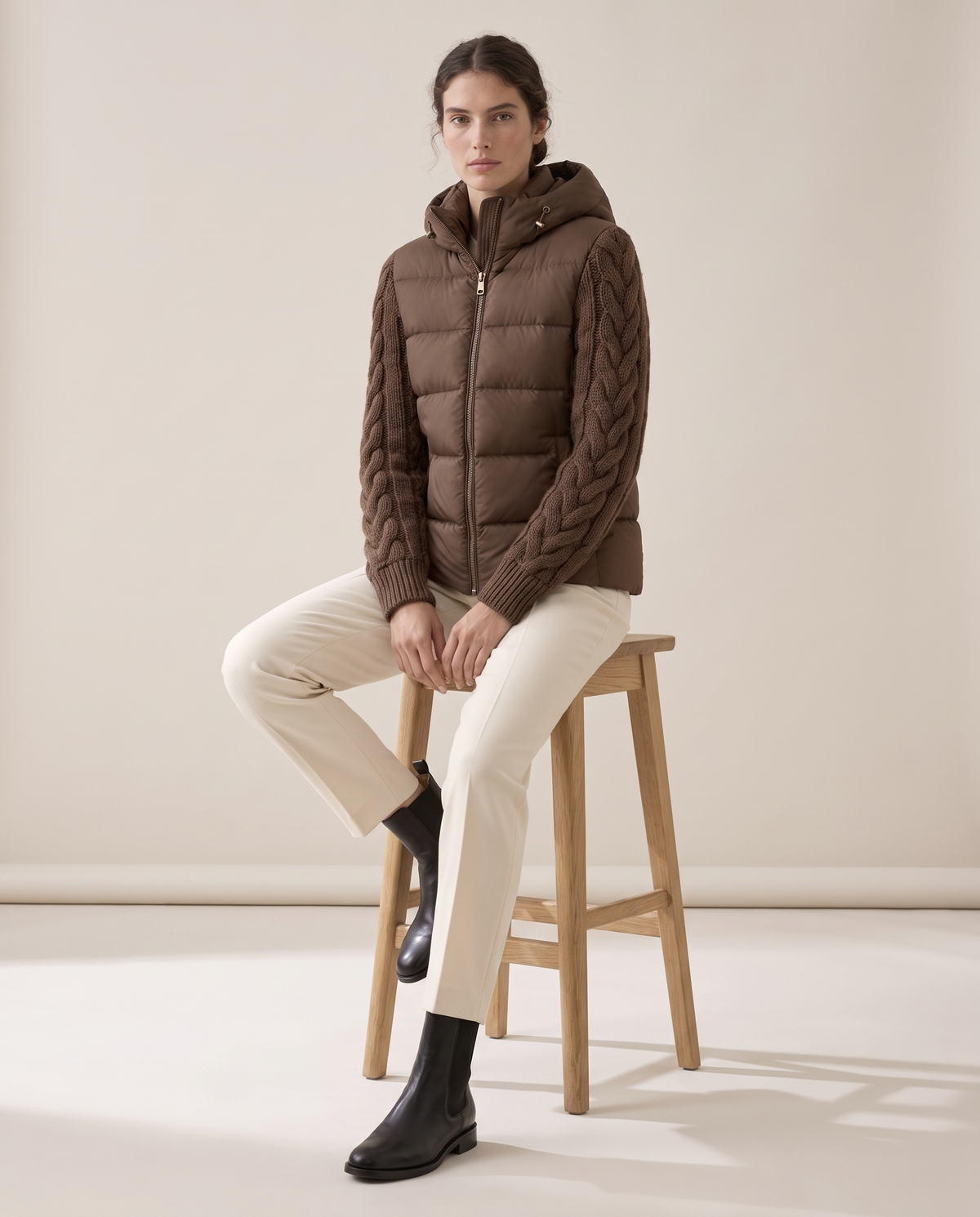 Down Puffer Jacket with Cable-Knit Sleeves — worn seated