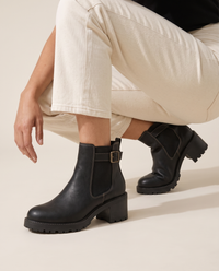 Chelsea Ankle Boots with Buckle Strap and Lug Sole — worn, crouching