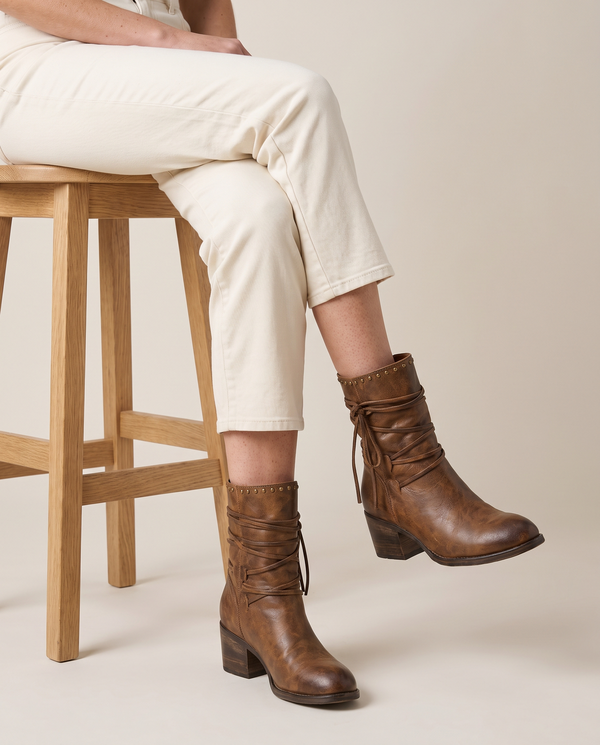 Lace-Up Western Ankle Boots with Studded Trim — worn seated