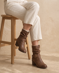 Slouch Ankle Boots with Buckle Strap — worn seated