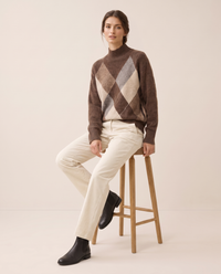 Weymouth Classic High Neck Color Block Argyle Sweater — worn seated