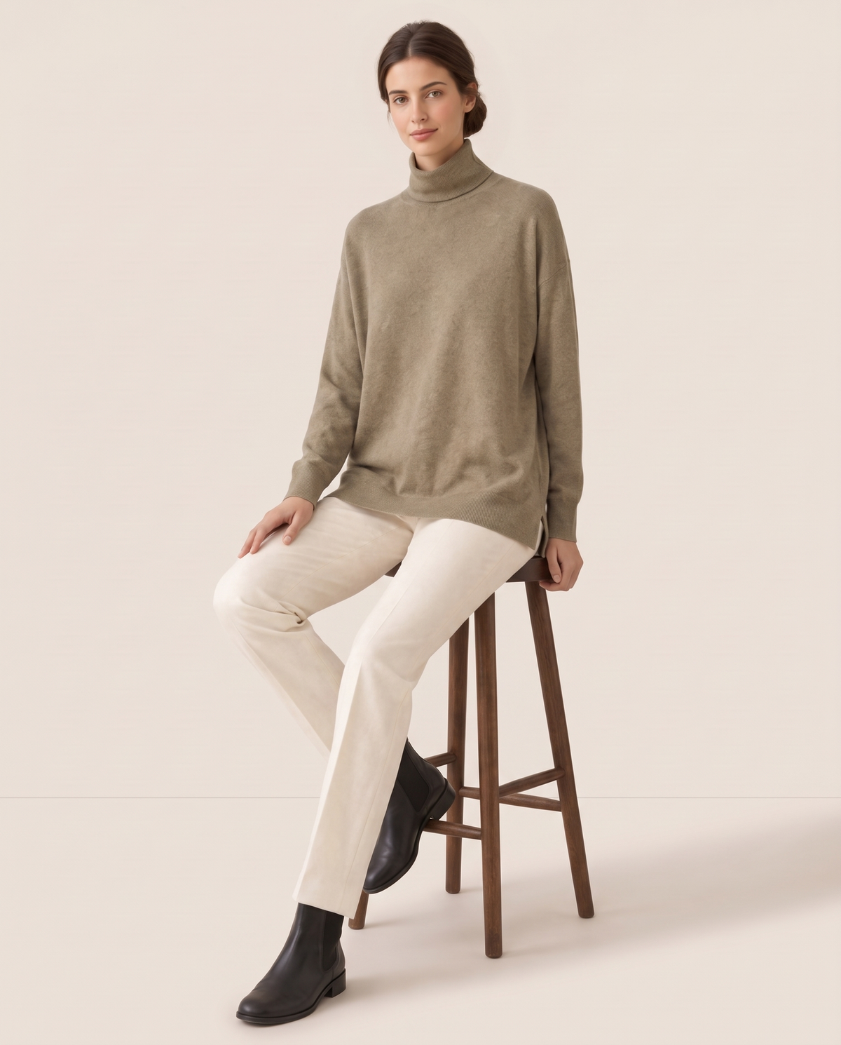 Erice Relaxed Loose-Fit Fine Knit Turtleneck Sweater — worn seated