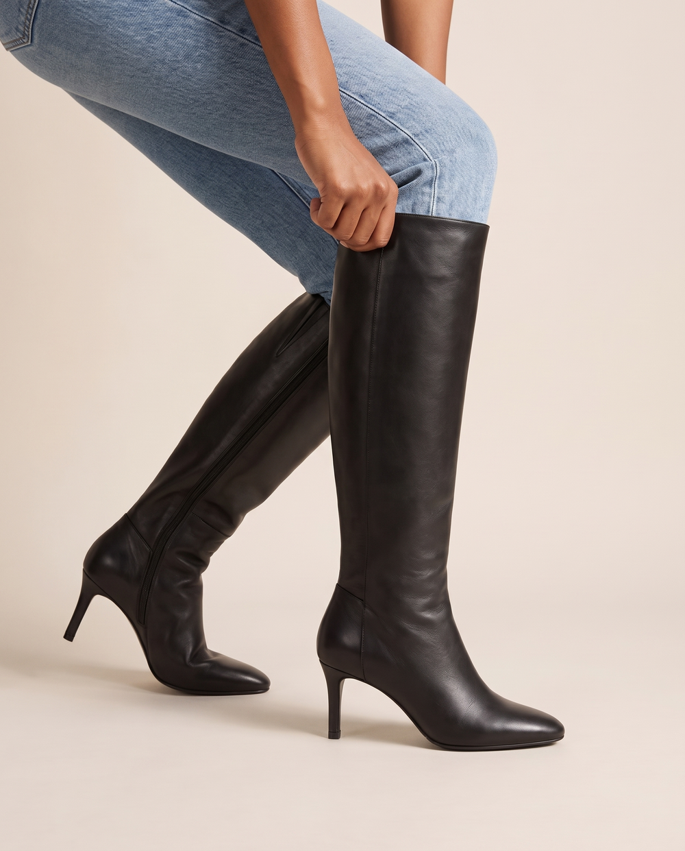 Leather Knee-High Boots with Slim Heel — pulling on the boot with jeans