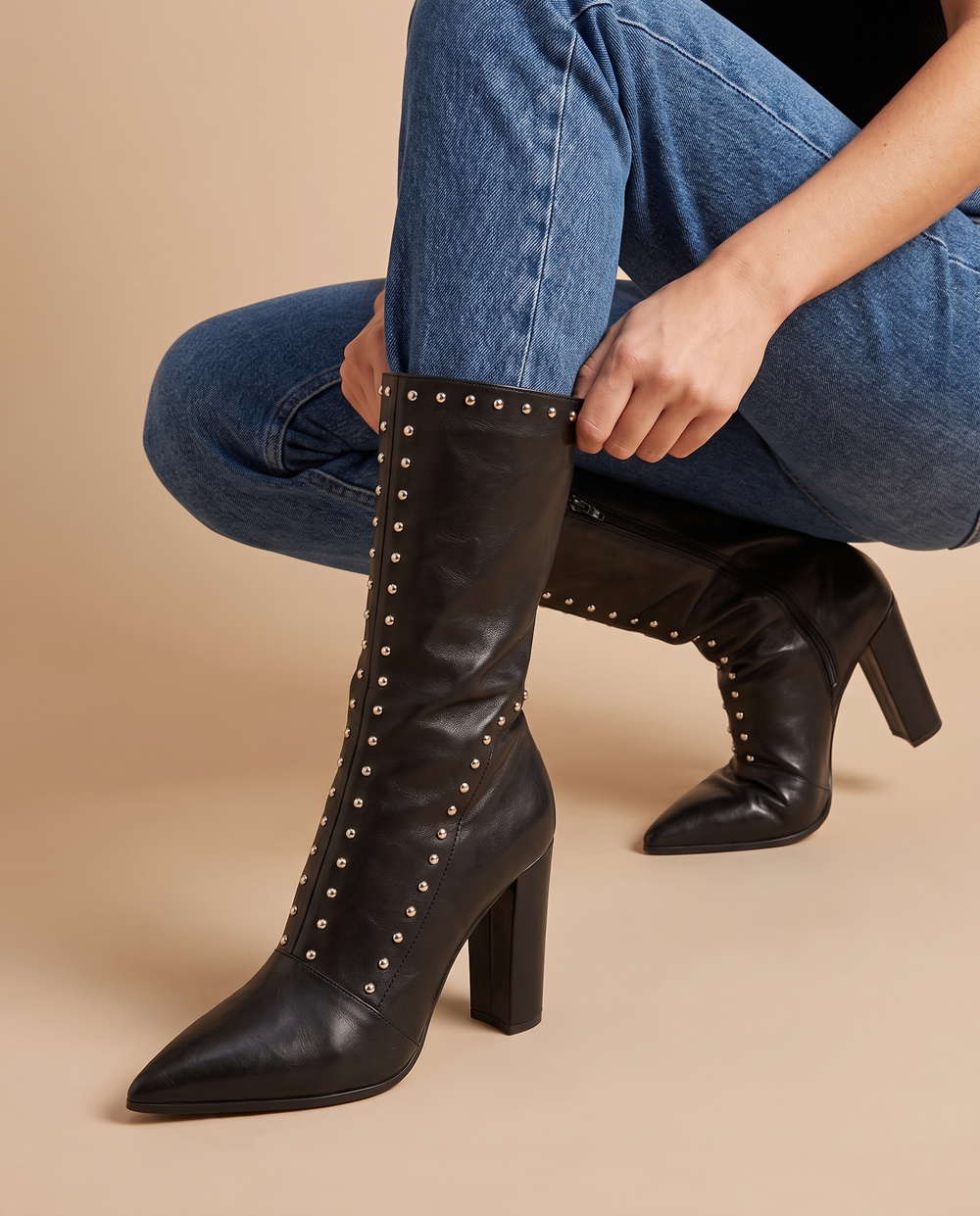 High-Cut Boots with Chunky Heel and Rivet Detail — pulling on the boot with jeans