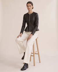 Cropped Fit-and-Flare Leather Jacket — worn seated