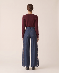 Back view of lace-inset wide-leg jeans with scalloped hem