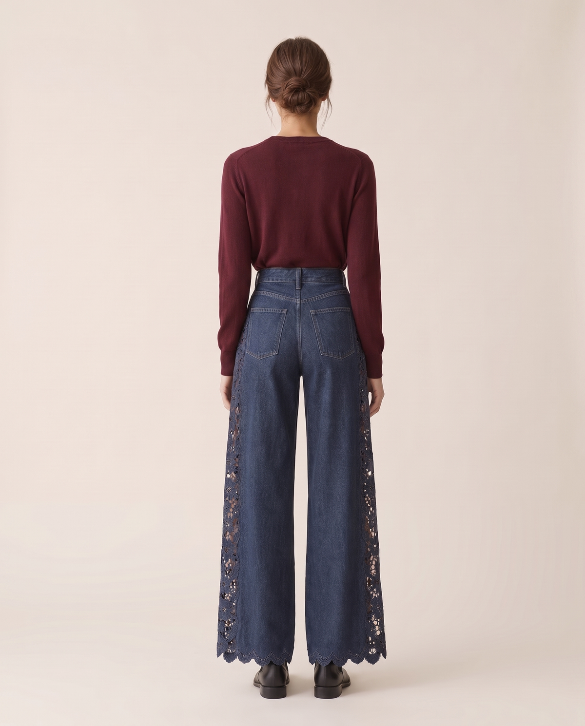 Back view of lace-inset wide-leg jeans with scalloped hem