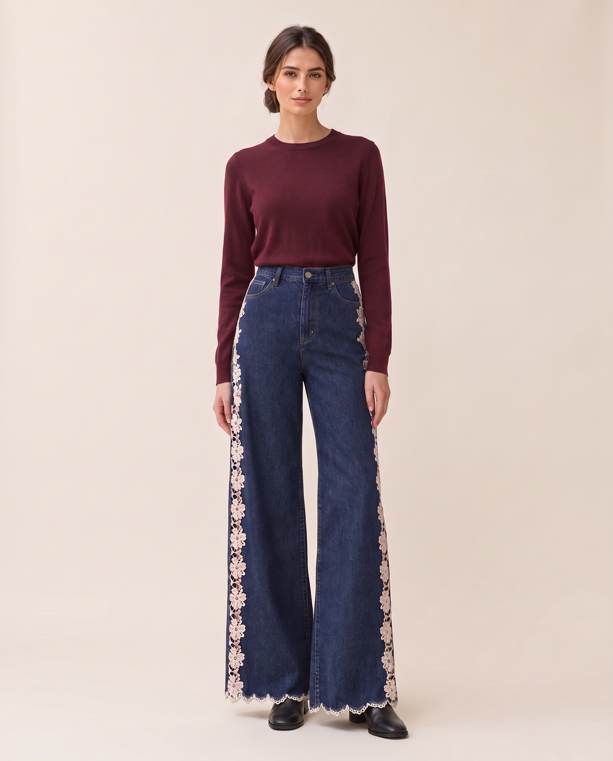Front view of lace-inset wide-leg jeans with a burgundy knit sweater