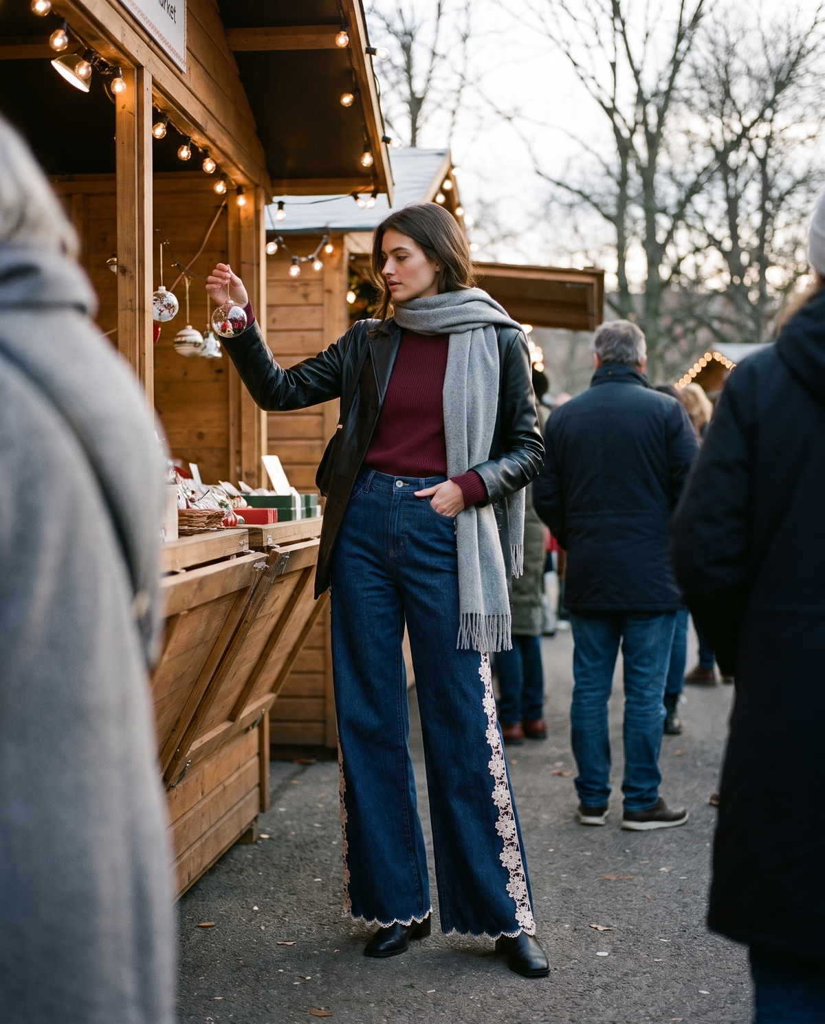 Lace-inset jeans worn with a leather jacket at a holiday market stall