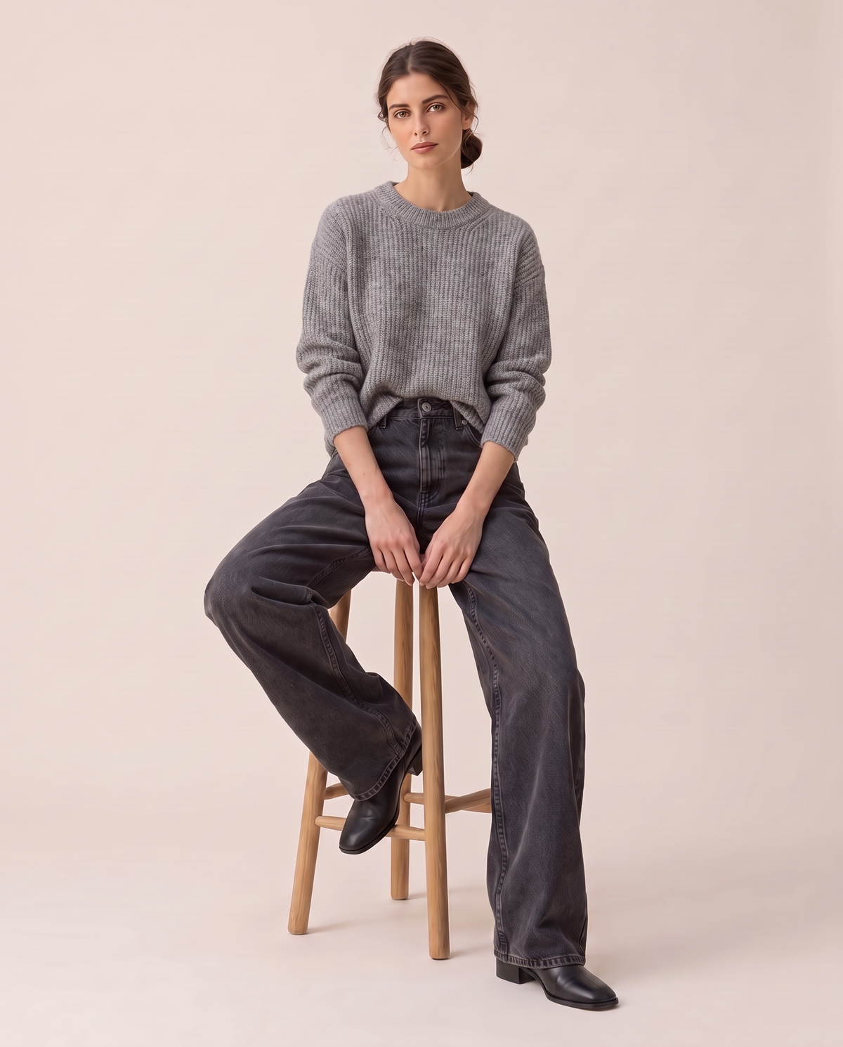Kristin Baggy Jeans in black wash, seated on a stool