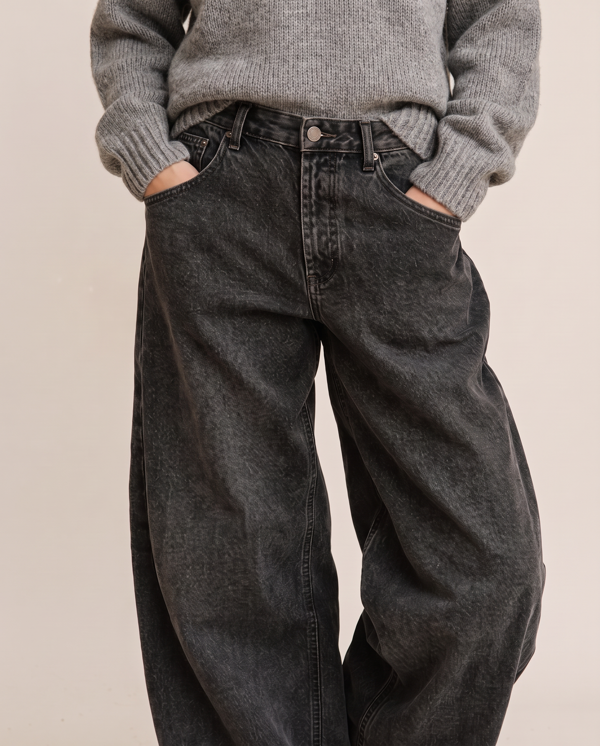 Kristin Baggy Jeans in black wash, waist-down view with grey sweater