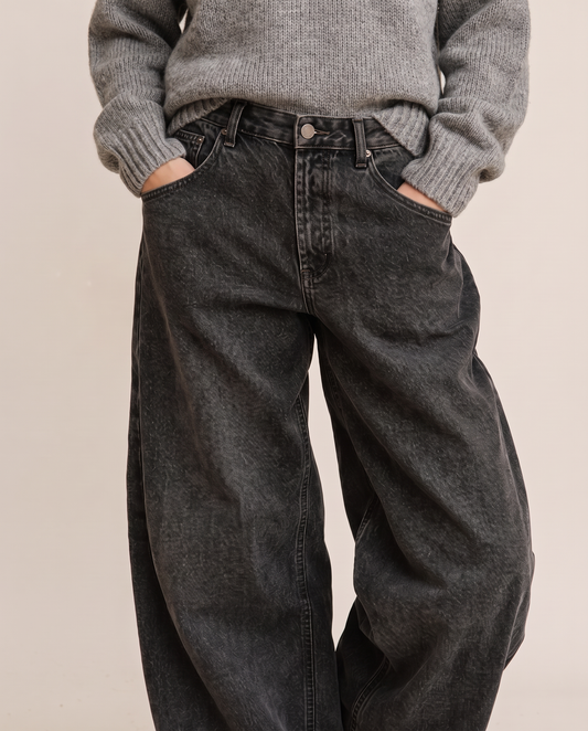 Kristin Baggy Jeans in black wash, waist-down view with grey sweater