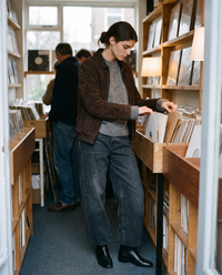 Kristin Baggy Jeans in black wash, browsing a vinyl record shop