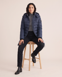 Hooded Down Puffer Jacket for Women — worn seated
