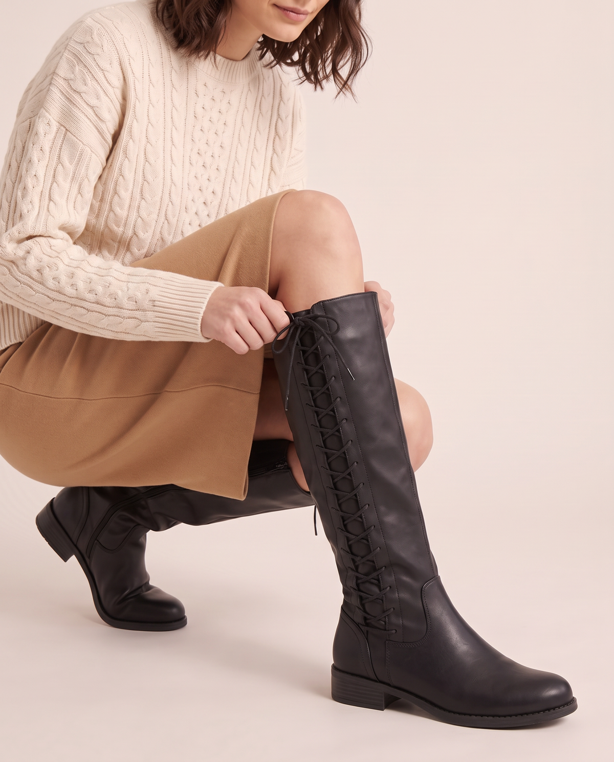 Lace-Up Knee-High Boots with Low Block Heel for Women — pulling on the boot