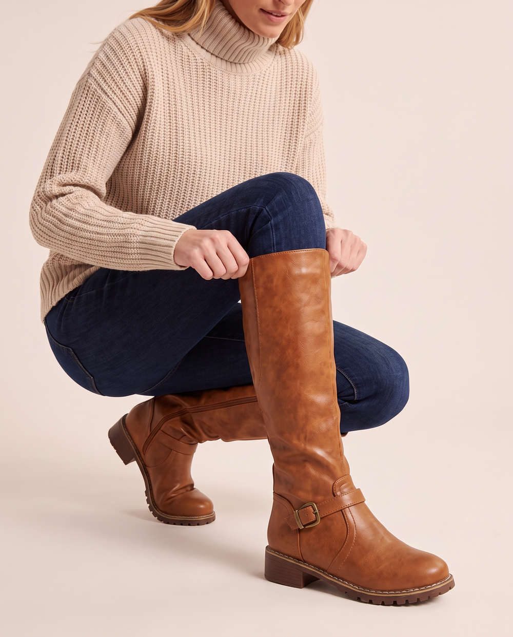 Knee-High Riding Boots with Buckle Strap for Women — pulling on the boot
